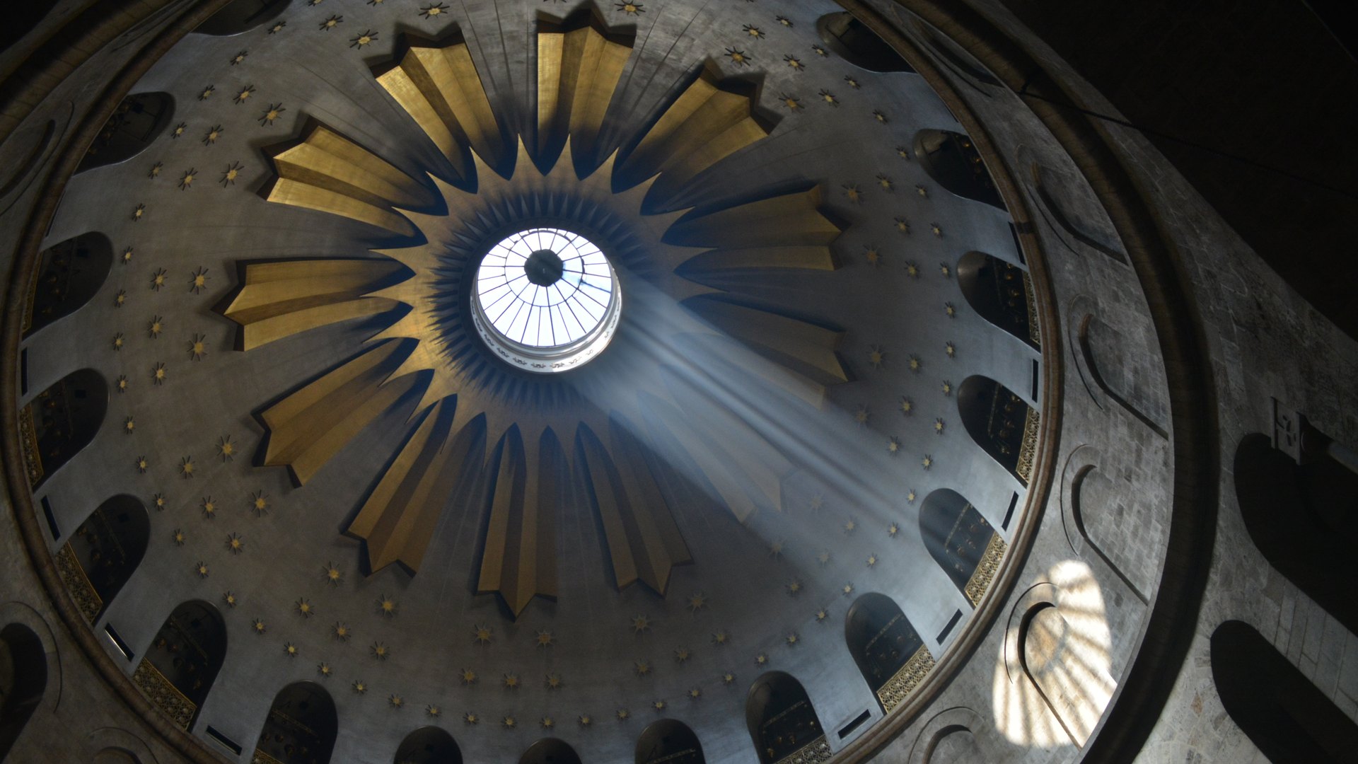 A shaft of daylight falling through the oculus of the great dome of the Church of the Holy Sepulchre in Jerusalem